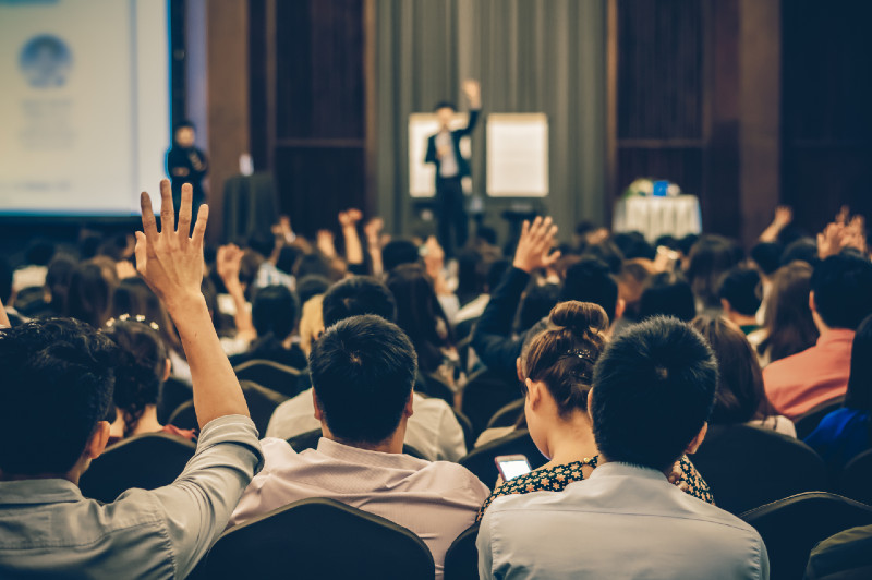 crowd listening to speaker at a conference