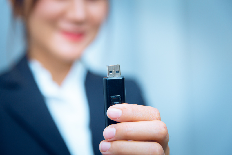 Woman holding USB flash drive