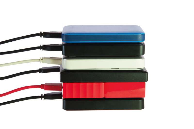 Blue, black, white, and red external hard drives stacked on top of each other
