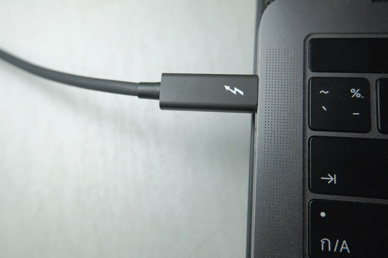 Black USB Type C plugged into laptop port. 