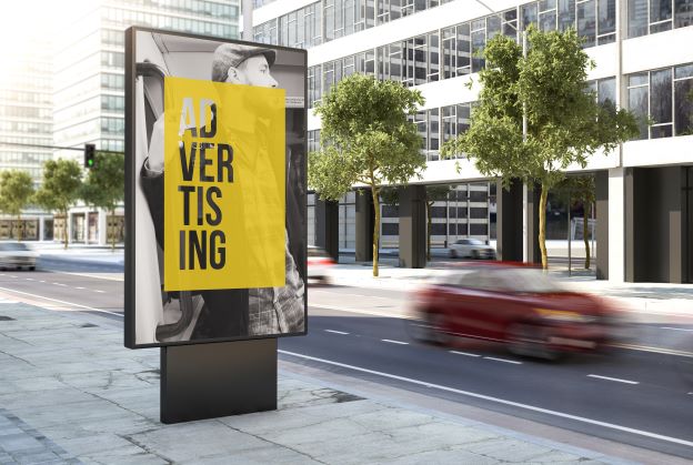 Digital billboard that reads "Advertising" as cars pass by 