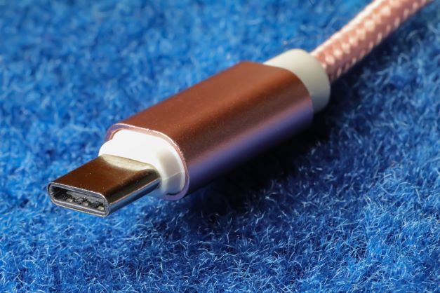 Rose gold USB Type-C on blue surface