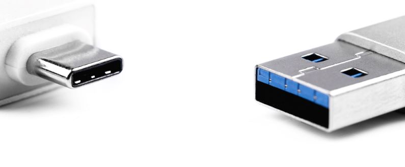 Type C drive and standard USB flash drives drives next to each other on white background