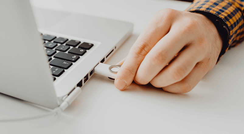 Person Plugging In a Thumb Drive 